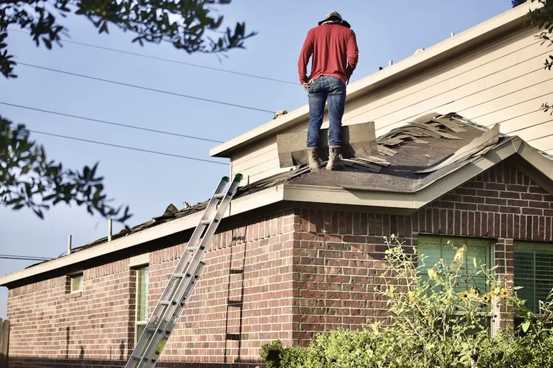 Professional roofer working on a residential roof in Harborcreek